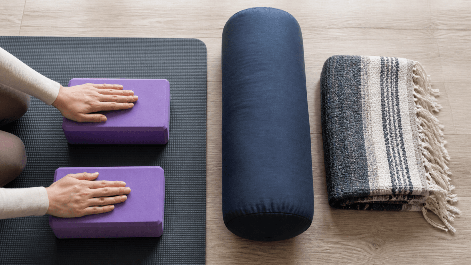 Yoga blocks, folded blanket, and bolster for wrist-friendly modifications